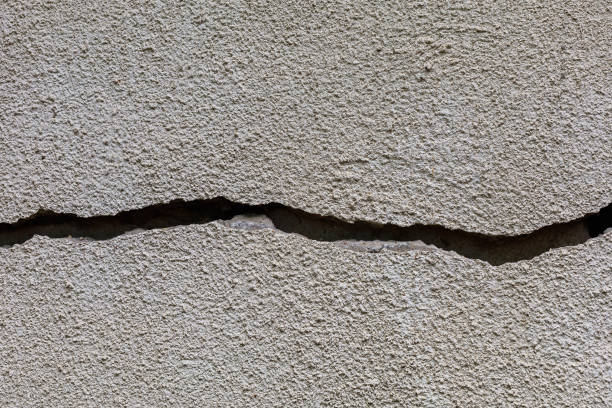 istock Crack in the wall. Rough textured surface. A background for a blank 1336271537