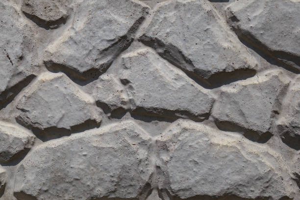 istock Decorative plaster imitating the shape of a natural stone. Rough textured surface. Background 1336271547
