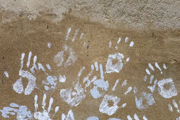 Photo of Handprints on the wall. Rough textured surface. Background for blank or graphic resource