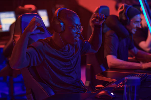istock Positive young Black guy in headphones gesturing hands like monkey while winning game, he participating in esports championship 1336273346