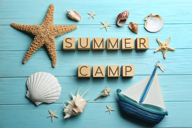istock Flat lay composition with phrase SUMMER CAMP made of cubes on light blue wooden background 1336273588