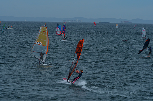Many young people are enjoying windsurfing on a fine, windy Sunday afternoon at Miura Beach, Miura City, Kanagawa Prefecture. Miura Beach is located at the entrance to Tokyo Bay from the Pacific Ocean.