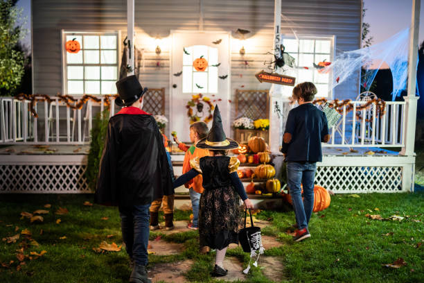 istock Young kids trick or treating at night during Halloween 1336273749