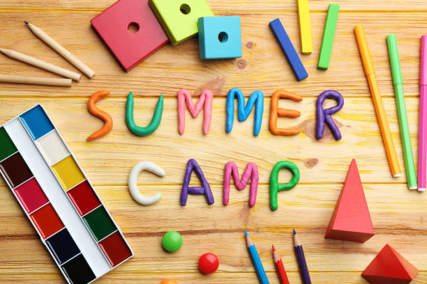 istock Flat lay composition with phrase SUMMER CAMP made of modelling clay on wooden background 1336273814