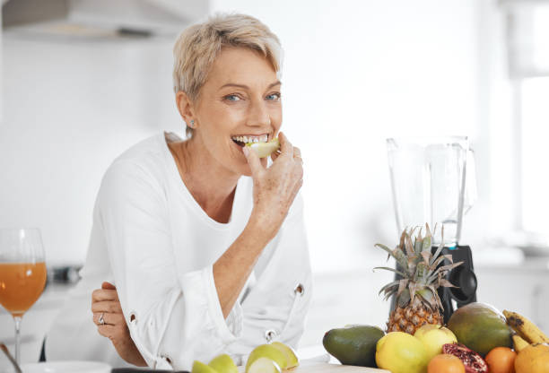 果物を食べる女性のショット - tasting women eating expressing positivity ストックフォトと画像