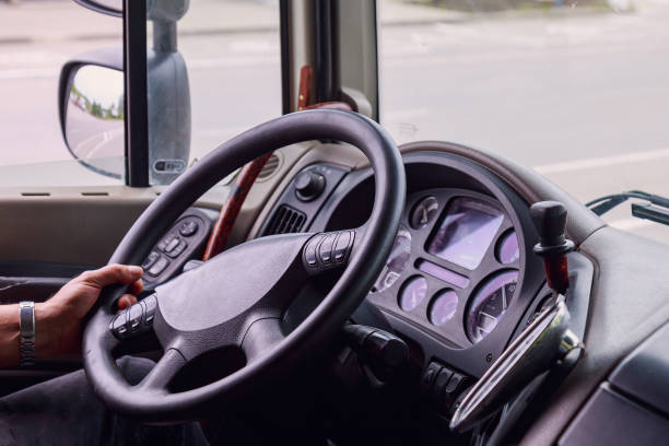 istock The hands of a professional driver on the steering wheel. Background with copy space for text 1336275901