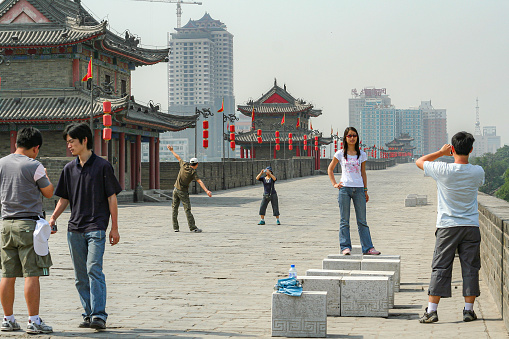 Visitors walk and pose for pictures  around one of the many lookout towers of the walled city of Xi'an.