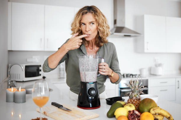 istock Shot of a woman tasting her smoothie before serving it 1336276340