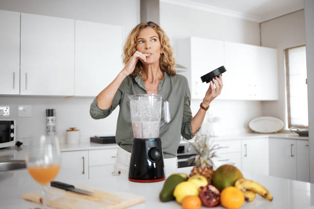 istock Shot of a woman tasting her smoothie before serving it 1336276341