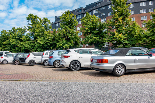 Cars parked near a housing estate