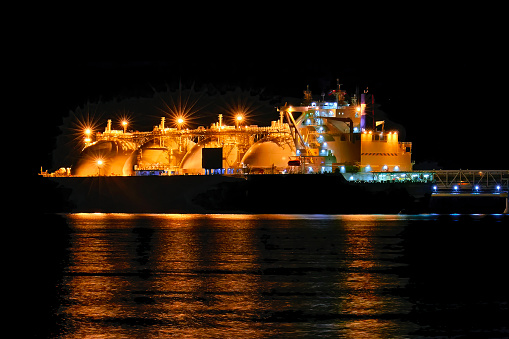 Metanero en puerto por la noche. Gaseoso en la terminal de GAS photo