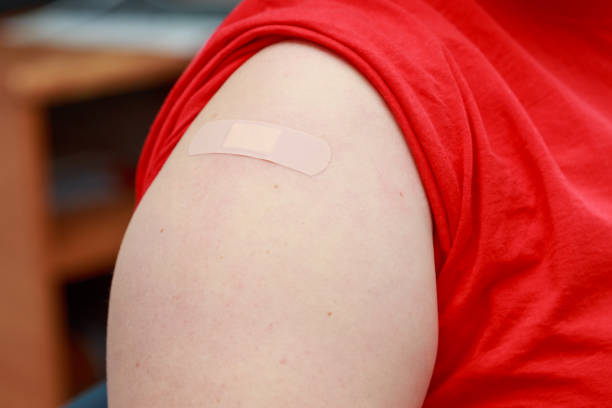 istock Patients shoulder with sealed plaster after coronavirus vaccination. Real procedure and situation 1336282982