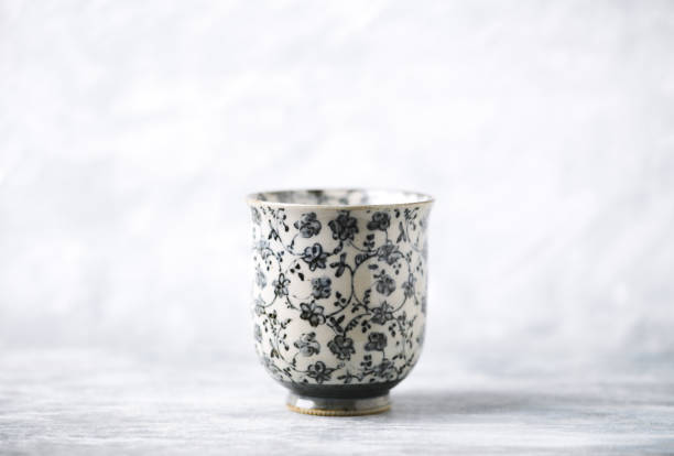 Traditional, handcrafted ceramic on bright wooden background. Soft focus. Copy space.