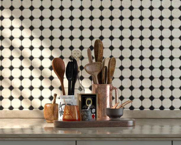 istock Front view kitchen with marble kitchen countertop and various wooden,  cutlery sets and jars on it under warm morning sunshine, ceramic small diamond tiles wall, 3d Rendering 1336285781