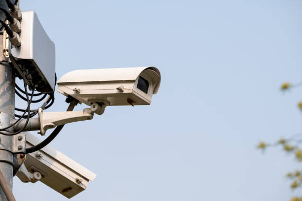 istock Closed-circuit camera attach on top of pole in park or public area for security reason with clear sky as background 1336286974