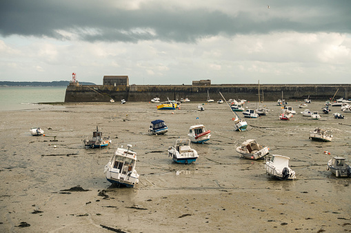 Boats lying on the sea floor at low tide near Granville