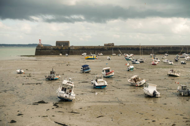 Boats lying on the sea floor at low tide near Granville stock photo