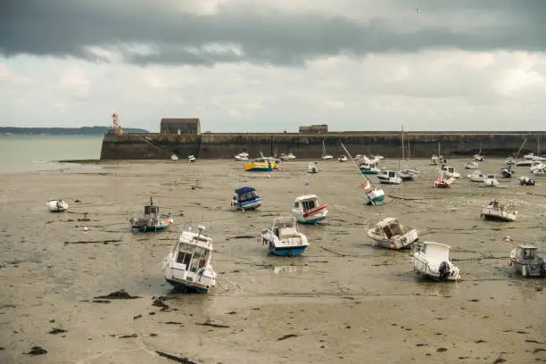 Photo of Boats lying on the sea floor at low tide near Granville
