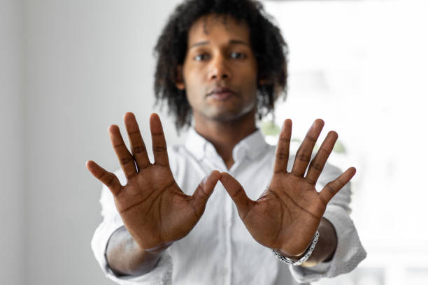 istock African-American man standing indoors and looking at the camera 1336295656
