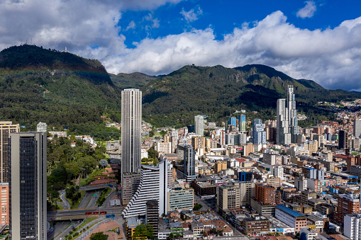 Aerial shot of the city center of Bogota, Colombia on a beautiful sunny day and showing the Edificio Colpatria and the mountains - urban scene concepts