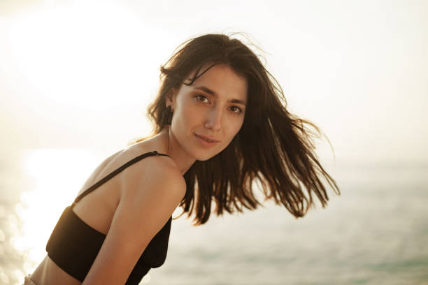 istock Young smiling woman outdoors portrait at beach 1336300311