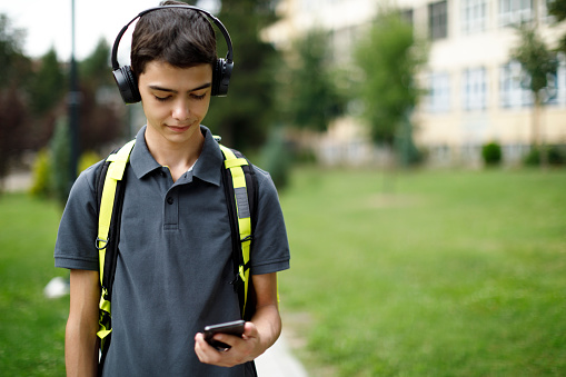 Teenage boy listening music from a smart phone