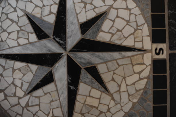 istock Black and white compass rose, sometimes called a wind rose or rose of the winds made with floor tiles on a floor mosaic 1336303520
