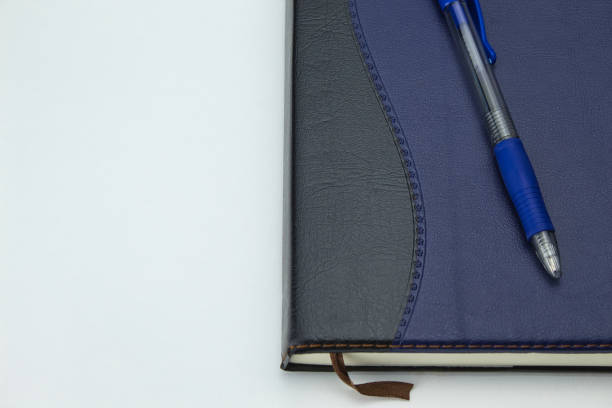 istock top view of a diary with a blue pen on top on a white background with copy space 1336306146