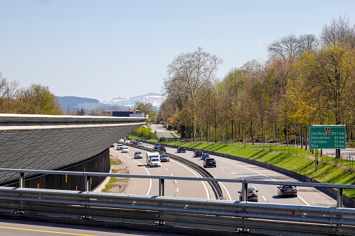 Bern, Switzerland - April 20, 2019: There is a highway that leads through the city. The traffic rushes in both directions. The city of Bern is a great destination and one of the many tourist attractions in Switzerland.