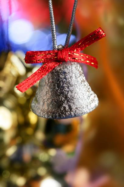 istock Silver bell in the christmas tree with red ribbon 1336311729