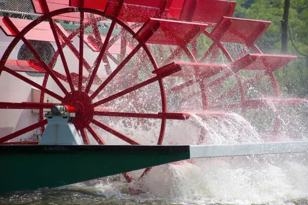 close up of red paddlewheel boat on a river