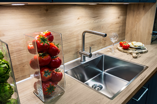 Modern kitchen house interior. Close-up of faucet and sink in the modern luxury kitchen.