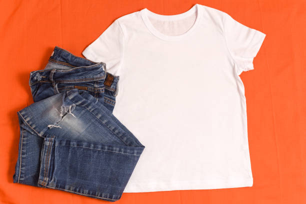 istock White t-shirt mockup and blue jeans on bright orange background 1336318480