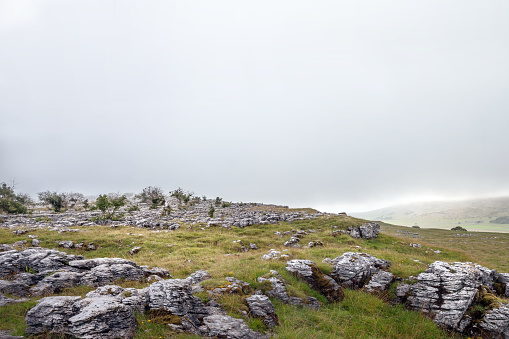 Shot on Ingleborough in the Yorkshire Dales with Large misty sky for copyspace.