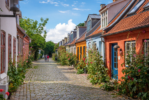 Aarhus, Denmark - August 25, 2021: Colourful old cottages on a quiet street in Aarhus, Denmark