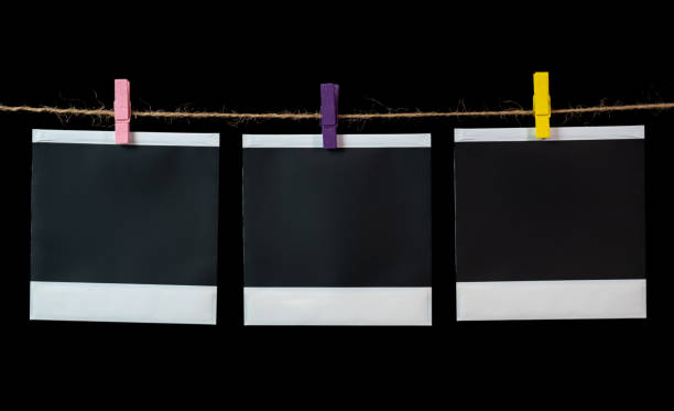 istock Blank square photo frames hanging on a clothesline. Blank square photo frames 1336323313