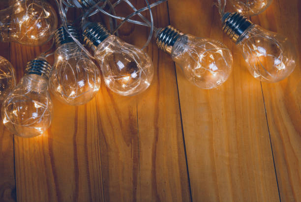 istock Light bulbs over wooden background 1336323705