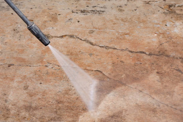 istock Worker cleaning dirty floor with high pressure washer 1336323718