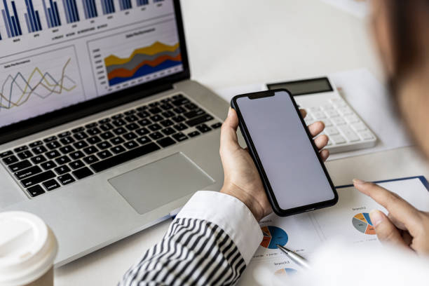 istock A businesswoman is holding a smartphone and using it, she is using a smartphone to send text messages to a company partner about financial statements. Concept of using technology in communication. 1336328252