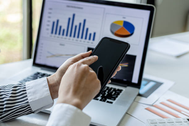 istock A businesswoman is holding a smartphone and using it, she is using a smartphone to send text messages to a company partner about financial statements. Concept of using technology in communication. 1336328263