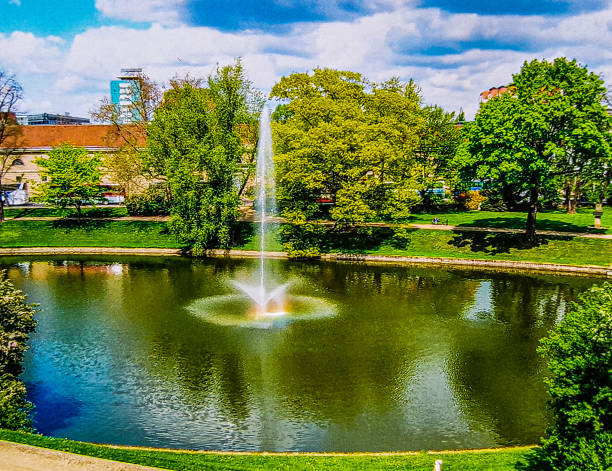 istock Fountain in the large pond with a small rainbow 1336328527