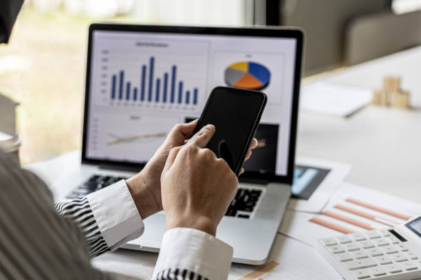 istock A businesswoman is holding a smartphone and using it, she is using a smartphone to send text messages to a company partner about financial statements. Concept of using technology in communication. 1336328533