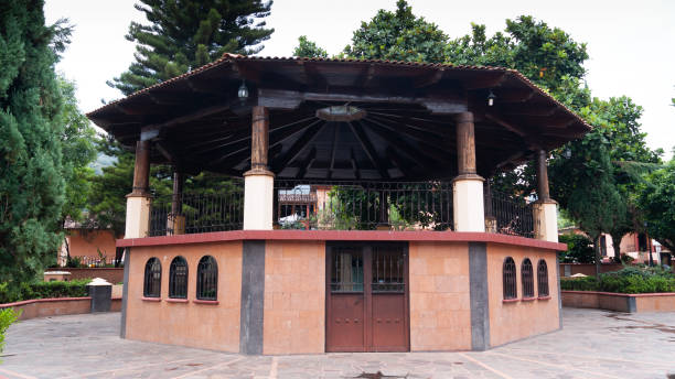 istock kiosk structure in town with door, windows and trees in the background 1336329060