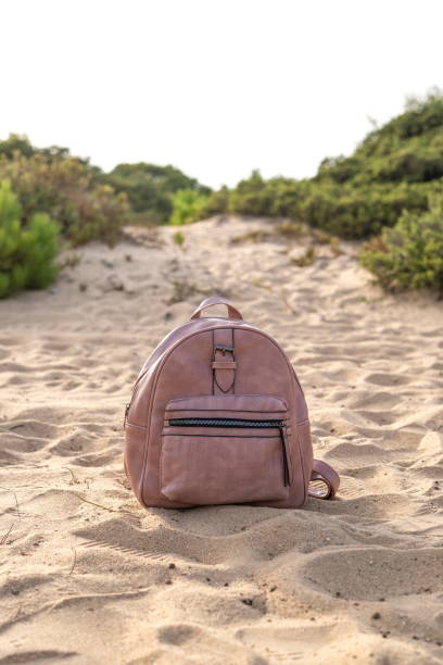 istock Leather bag on the sand. Theft concept 1336330968