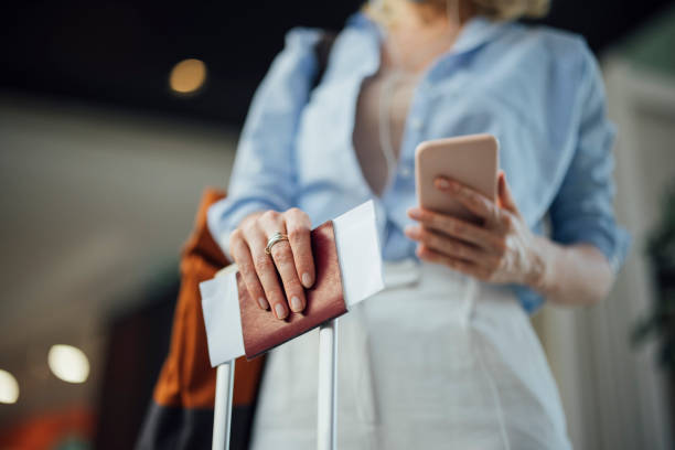 istock An Anonymous Business Woman Using Mobile Phone at the Airport 1336331273