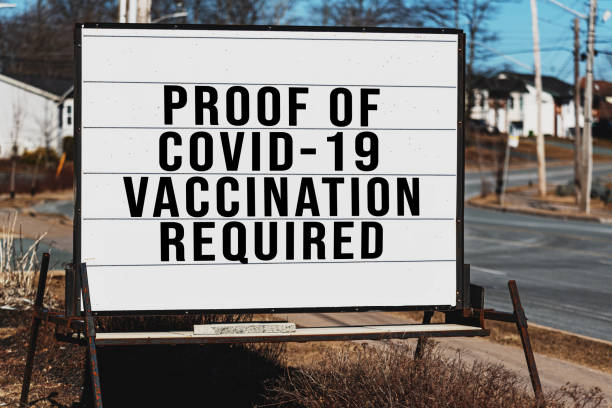 Retail Store Requires Vaccination Roadside signage for a store that requires proof of Covid-19 vaccination. anti vaccination stock pictures, royalty-free photos & images