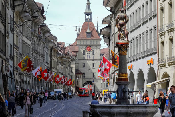 The facade of the Clock Tower in Bern Bern, Switzerland - April 23, 2019: The facade of the Clock Tower and there is a fountain, which are located in the Old Town. These are the most recognized monuments of the city. The City of Bern is one of the countless great places in Switzerland and it is the political centre of this Country. Numerous museums, a wide cultural offer, a variety of tourist attractions makes it a travel destination for tourists from all over the world. bern photos stock pictures, royalty-free photos & images