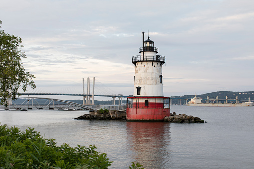 The Tarrytown Lighthouse as seen just before daybreak with the Governor Mario m. Cuomo Bridge in the background.