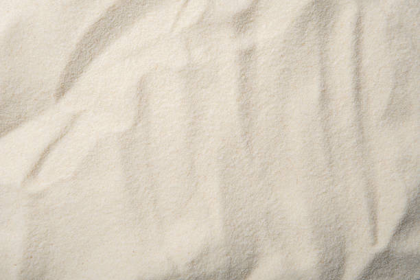 istock sand texture. Sandy beach for background In Summer Sun. Top view 1336344884