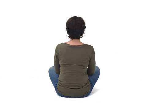 rear view of a woman sitting on white background